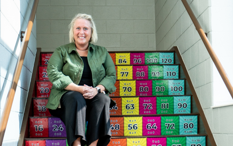 Jessica Struble sits on a stairway at Sam Adams Elementary School.