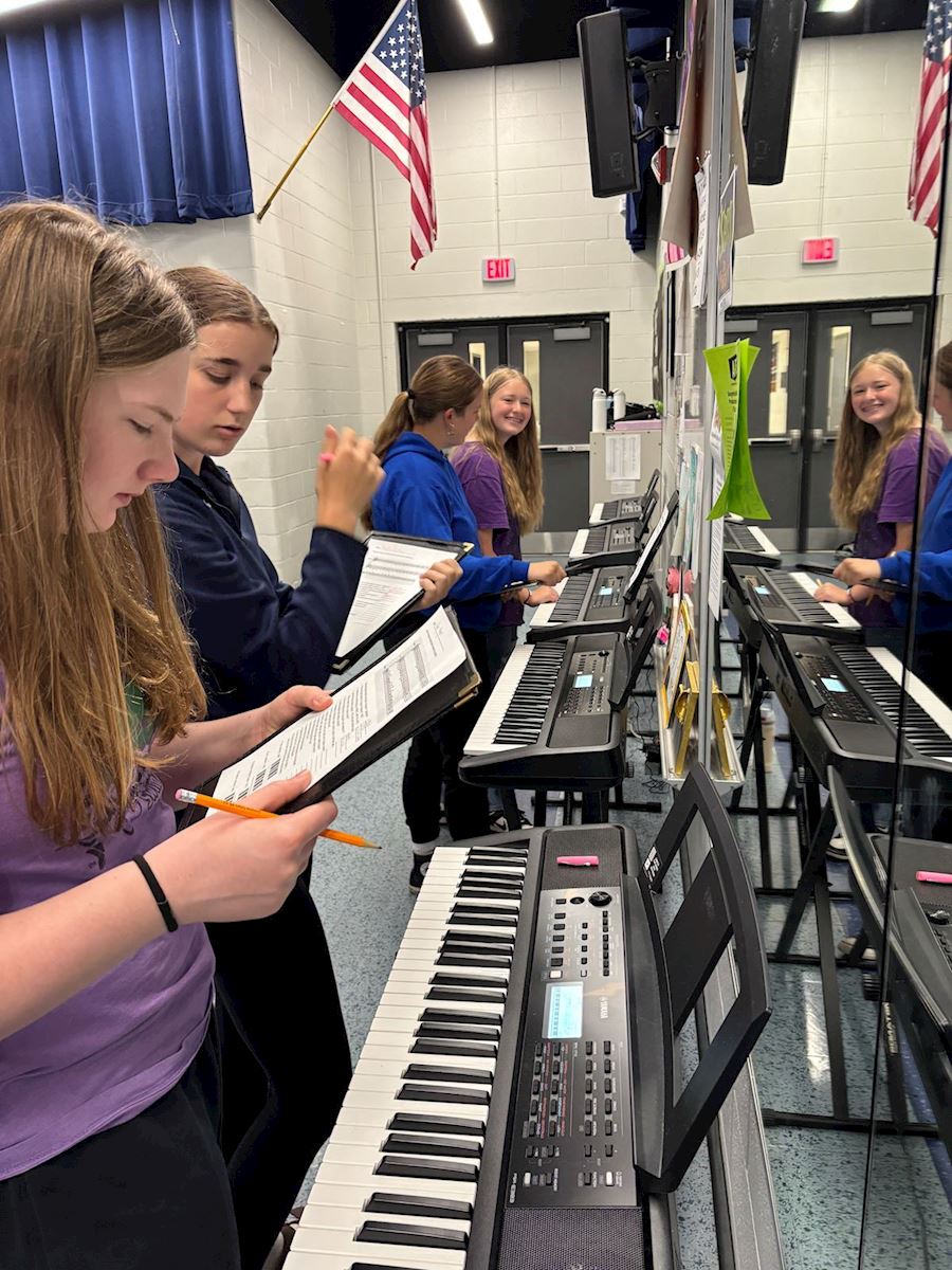 Photo of a student practicing at piano exploration camp