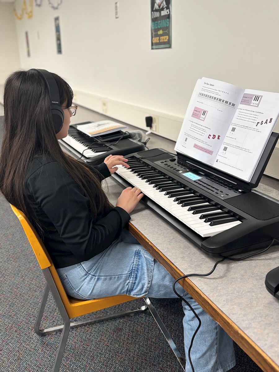 Photo of a student practicing at piano exploration camp