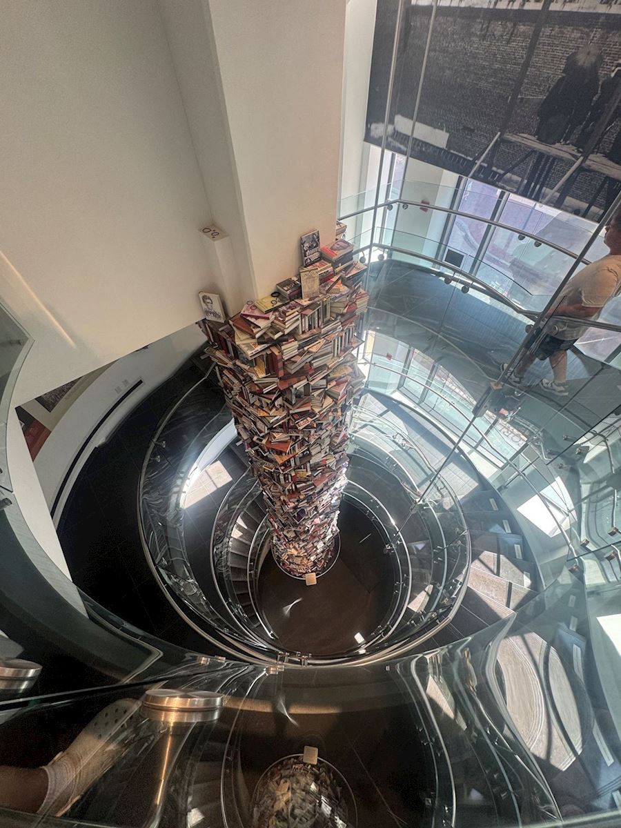 Photo of a stack of books on a spiral staircase