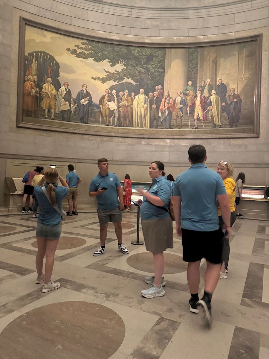 Photo of students in front of a mural