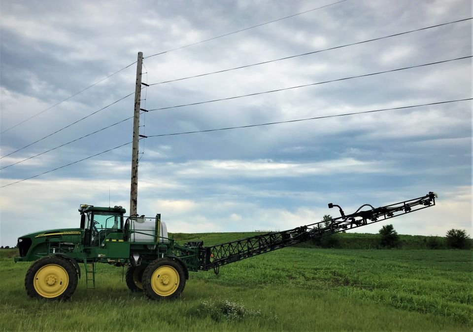 Farm equipment navigating under electric lines