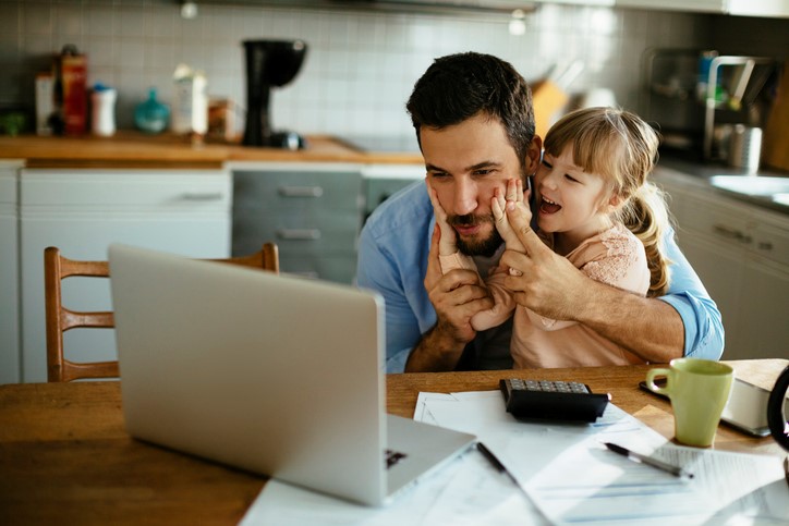 Father and daughter looking at a computer